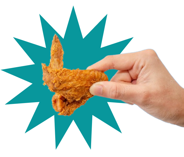 Hand holding chicken wing